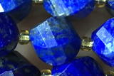 TWIS12 15 inches 9*10mm faceted twisted lapis lazuli beads